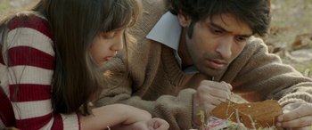 Movie still from “A Death in the Gunj” (2016), directed by Konkona Sen Sharma – A man and a woman looking at a piece of paper; Close Up shot, High angle