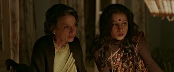 Movie still from “A Death in the Gunj” (2016), directed by Konkona Sen Sharma – Two women standing next to each other in a dark room; Close Up shot, High angle