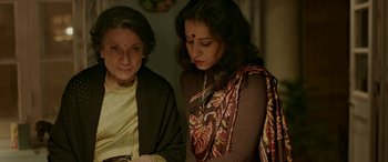 Movie still from “A Death in the Gunj” (2016), directed by Konkona Sen Sharma – Two women are looking at something on a table; Close Up shot, High angle