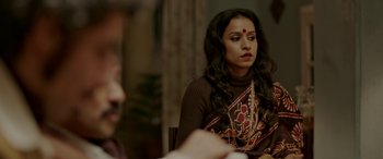 Movie still from “A Death in the Gunj” (2016), directed by Konkona Sen Sharma – A woman sitting at a dinner table looking at the camera; Close Up shot, Over the shoulder angle