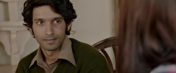 Movie still from “A Death in the Gunj” (2016), directed by Konkona Sen Sharma – A person sitting in a chair; Close Up shot, Over the shoulder angle