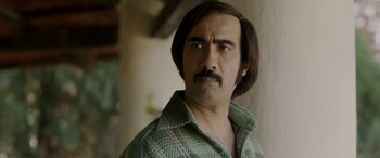 Movie still from “A Death in the Gunj” (2016), directed by Konkona Sen Sharma – A person with a beard and mustache; Close Up shot, Low angle