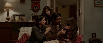 Movie still from “A Death in the Gunj” (2016), directed by Konkona Sen Sharma – A group of people sitting on top of a couch; Medium shot, High angle