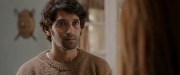 Movie still from “A Death in the Gunj” (2016), directed by Konkona Sen Sharma – A person wearing a brown sweater; Close Up shot, Over the shoulder angle