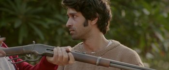 Movie still from “A Death in the Gunj” (2016), directed by Konkona Sen Sharma – A man holding a rifle in his hands; Close Up shot, Over the shoulder angle
