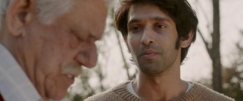Movie still from “A Death in the Gunj” (2016), directed by Konkona Sen Sharma – A man in a brown sweater looking at another man in a brown sweater; Close Up shot, Over the shoulder angle