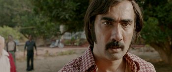 Movie still from “A Death in the Gunj” (2016), directed by Konkona Sen Sharma – A person with a mustache; Close Up shot, Low angle