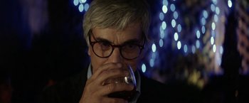 Movie still from “A Fantastic Woman” (2017), directed by Sebastián Lelio – An older man drinking a glass of red wine; Close Up shot, Over the shoulder angle