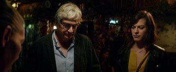 Movie still from “A Fantastic Woman” (2017), directed by Sebastián Lelio – An older man with white hair wearing glasses and a black jacket; Close Up shot, Over the shoulder angle