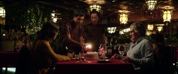 Movie still from “A Fantastic Woman” (2017), directed by Sebastián Lelio – A man lighting a candle on top of a birthday cake; Medium shot, Over the shoulder angle