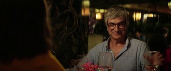 Movie still from “A Fantastic Woman” (2017), directed by Sebastián Lelio – An older man sitting at a table with glasses of wine; Close Up shot, Over the shoulder angle