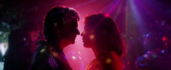 Movie still from “A Fantastic Woman” (2017), directed by Sebastián Lelio – A man and a woman face to face in a room lit with purple lights; Close Up shot, Low angle