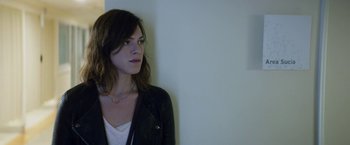 Movie still from “A Fantastic Woman” (2017), directed by Sebastián Lelio – A woman standing next to a white wall; Close Up shot, Over the shoulder angle