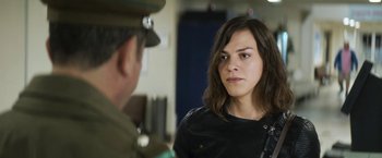 Movie still from “A Fantastic Woman” (2017), directed by Sebastián Lelio – A woman in a black shirt is looking at a man in a uniform; Close Up shot, Over the shoulder angle