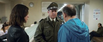 Movie still from “A Fantastic Woman” (2017), directed by Sebastián Lelio – A man in a uniform talking to another man; Medium shot, Over the shoulder angle