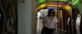 Movie still from “A Fantastic Woman” (2017), directed by Sebastián Lelio – A woman walking down a hallway in a building; Medium shot, Over the shoulder angle