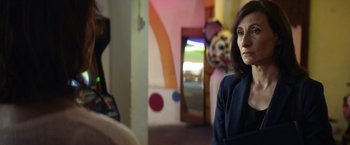 Movie still from “A Fantastic Woman” (2017), directed by Sebastián Lelio – A woman is sitting in a room looking at the camera; Close Up shot, Over the shoulder angle