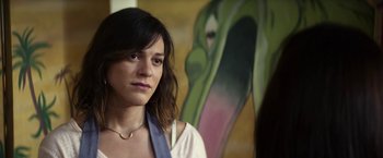 Movie still from “A Fantastic Woman” (2017), directed by Sebastián Lelio – A woman standing in front of a painting of a snake; Close Up shot, Over the shoulder angle