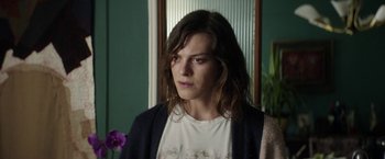 Movie still from “A Fantastic Woman” (2017), directed by Sebastián Lelio – A woman with long brown hair wearing a white t - shirt; Close Up shot, Over the shoulder angle