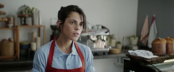 Movie still from “A Fantastic Woman” (2017), directed by Sebastián Lelio – A woman wearing an apron in a kitchen; Close Up shot, Over the shoulder angle