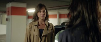 Movie still from “A Fantastic Woman” (2017), directed by Sebastián Lelio – A woman standing in front of a car in a parking lot; Close Up shot, Over the shoulder angle