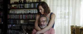 Movie still from “A Fantastic Woman” (2017), directed by Sebastián Lelio – An older man and a younger woman are hugging; Close Up shot, Low angle