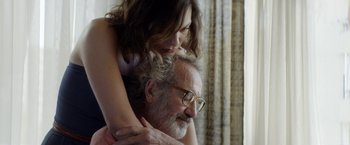 Movie still from “A Fantastic Woman” (2017), directed by Sebastián Lelio – An older man and a young woman are hugging; Close Up shot, Over the shoulder angle