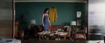 Movie still from “A Fantastic Woman” (2017), directed by Sebastián Lelio – A woman standing in front of a coffee table; Medium shot, High angle