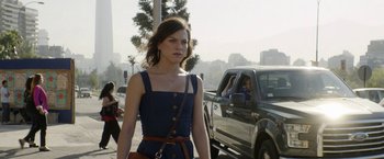 Movie still from “A Fantastic Woman” (2017), directed by Sebastián Lelio – A woman in a blue dress walking down a street; Medium shot, Over the shoulder angle