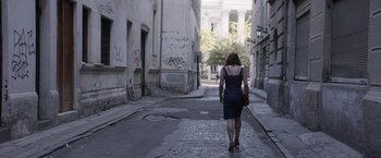 Movie still from “A Fantastic Woman” (2017), directed by Sebastián Lelio – A woman walking down a street in a dress; Wide shot, High angle