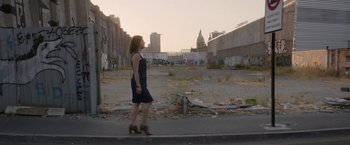Movie still from “A Fantastic Woman” (2017), directed by Sebastián Lelio – A woman walking down a street past a building; Wide shot, Low angle