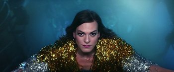 Movie still from “A Fantastic Woman” (2017), directed by Sebastián Lelio – A woman in a sequined jacket is posing for a picture; Close Up shot, Low angle