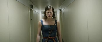 Movie still from “A Fantastic Woman” (2017), directed by Sebastián Lelio – A woman in a blue dress is walking down a hallway; Medium shot, Low angle