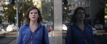 Movie still from “A Fantastic Woman” (2017), directed by Sebastián Lelio – A woman standing in front of a mirror on the sidewalk; Close Up shot, Over the shoulder angle