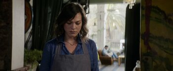 Movie still from “A Fantastic Woman” (2017), directed by Sebastián Lelio – A woman wearing an apron standing next to a man; Medium shot, Over the shoulder angle