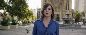 Movie still from “A Fantastic Woman” (2017), directed by Sebastián Lelio – A woman in a blue shirt is standing on the sidewalk; Close Up shot, Over the shoulder angle