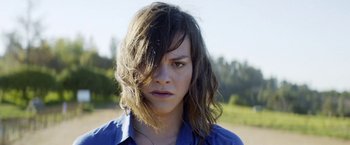 Movie still from “A Fantastic Woman” (2017), directed by Sebastián Lelio – A person wearing a blue shirt; Close Up shot, Low angle