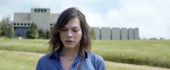 Movie still from “A Fantastic Woman” (2017), directed by Sebastián Lelio – A young woman with long brown hair wearing a blue shirt; Close Up shot, Over the shoulder angle