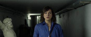Movie still from “A Fantastic Woman” (2017), directed by Sebastián Lelio – A woman in a blue shirt is standing in a hallway; Close Up shot, High angle