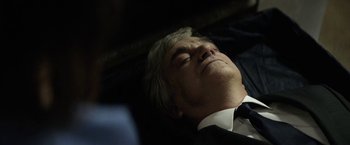 Movie still from “A Fantastic Woman” (2017), directed by Sebastián Lelio – An older man in a black suit sleeping on a bed; Close Up shot, High angle