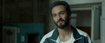 Movie still from “A Hero” (2021), directed by Asghar Farhadi – A person with a beard; Close Up shot, Over the shoulder angle