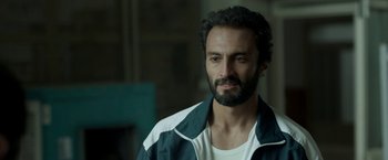 Movie still from “A Hero” (2021), directed by Asghar Farhadi – A person with a beard; Close Up shot, Over the shoulder angle