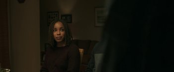 Movie still from “A Journal for Jordan” (2021), directed by Denzel Washington – A young woman sitting in front of a man in a living room; Close Up shot, Over the shoulder angle
