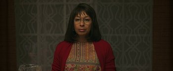 Movie still from “A Journal for Jordan” (2021), directed by Denzel Washington – A woman wearing glasses and a red sweater; Close Up shot, Low angle