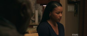 Movie still from “A Journal for Jordan” (2021), directed by Denzel Washington – A woman sitting at a table looking at the camera; Close Up shot, Over the shoulder angle