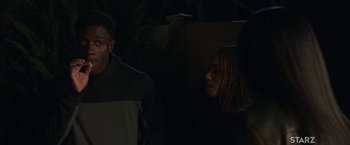 Movie still from “A Journal for Jordan” (2021), directed by Denzel Washington – A group of people standing next to each other in the dark; Medium shot, Over the shoulder angle