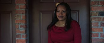 Movie still from “A Journal for Jordan” (2021), directed by Denzel Washington – A woman in a red dress smiling for the camera; Close Up shot, Over the shoulder angle