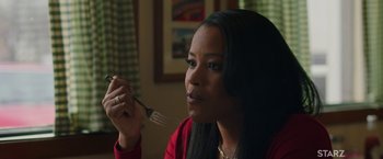 Movie still from “A Journal for Jordan” (2021), directed by Denzel Washington – A woman sitting at a table holding a fork in front of her face; Close Up shot, Over the shoulder angle