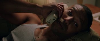 Movie still from “A Journal for Jordan” (2021), directed by Denzel Washington – A woman laying in bed talking on a phone; Close Up shot, Overhead angle