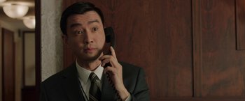 Movie still from “A Journal for Jordan” (2021), directed by Denzel Washington – A man wearing a suit and tie talking on a phone; Close Up shot, Low angle